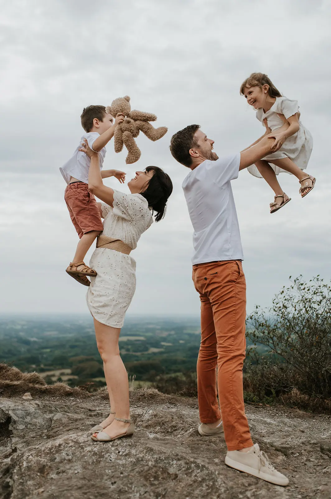 Des parents soulèvent leurs enfants à bout de bras.