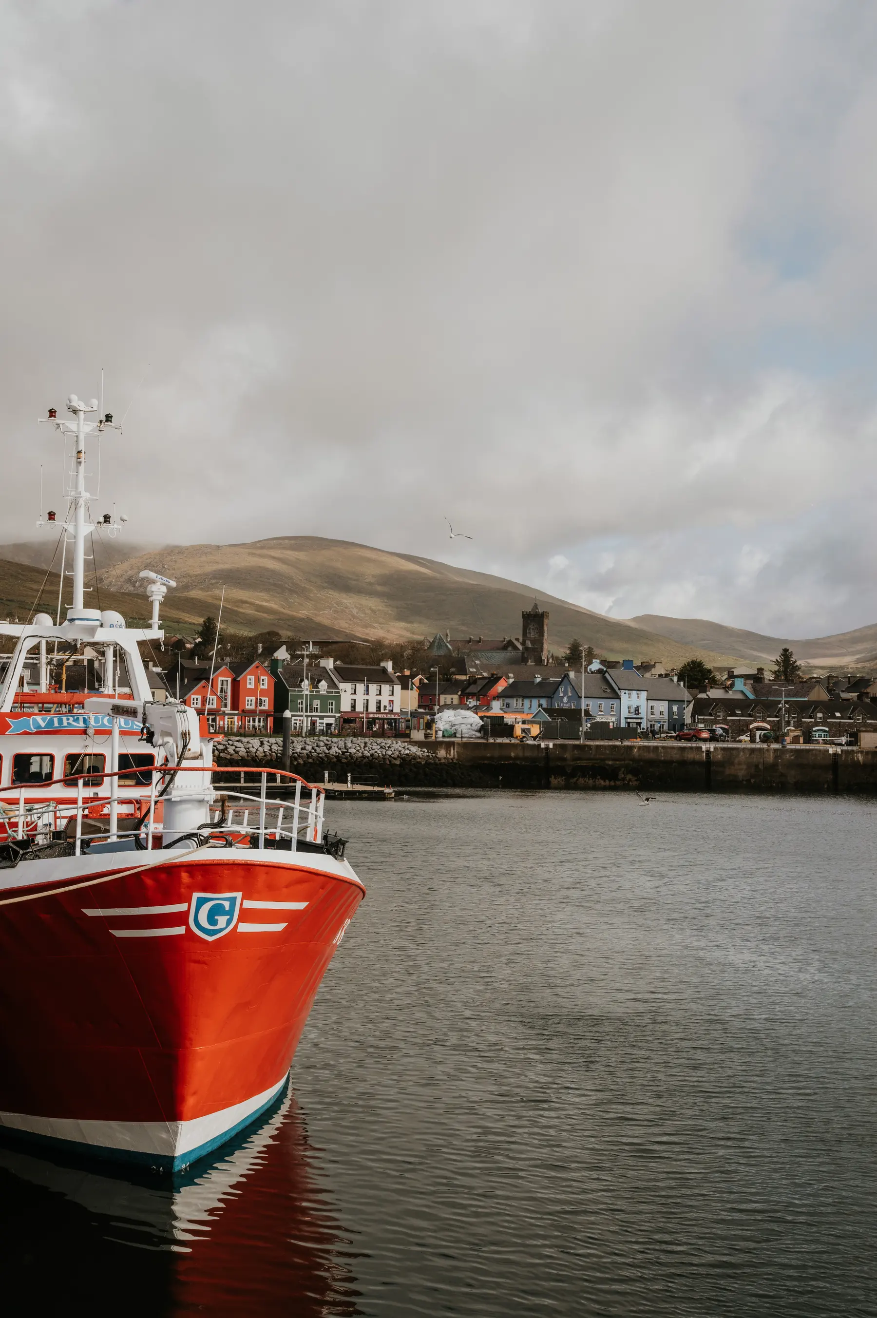 Un bateau de pêche rouge amarré dans un port.